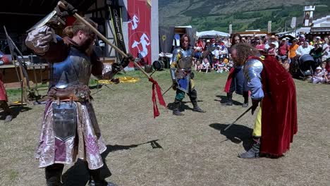 A-comical-fighting-scene-with-weapons-performed-by-Burdyri,-a-professional-sword-and-stage-combat-team,-during-the-South-Tyrolean-Medieval-Games-2023