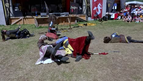 A-comical-fighting-scene-with-weapons-performed-by-Burdyri,-a-professional-sword-and-stage-combat-team,-during-the-South-Tyrolean-Medieval-Games-2023
