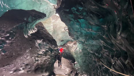 Tourists-admiring-the-stunning-crystal-blue-ice-cave-of-South-Iceland
