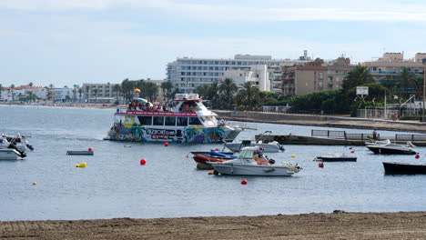 Ibz-Boat-arriving-at-port-of-Ibiza-on-sunny-day,-tourists-enjoying-holidays