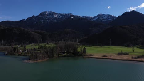 An-accent-drone-shot-of-mountains-of-Großweil-with-the-river-Loisach
