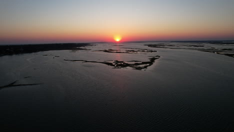 Drone-shot-of-the-sun-setting-over-Bogue-Sound-in-North-Carolina