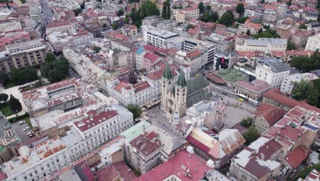 Sacred-heart-Cathedral-in-urban-city-Sarajevo,-Bosnia-and-Herzegovina,-aerial