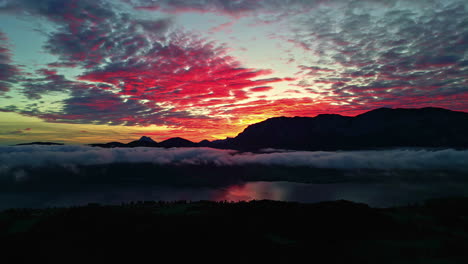 Aerial-drone-lateral-shot-of-a-dramatic-red-sunset-in-Lake-Attersee