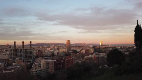 Barcelona-Three-Chimneys-Panoramic-Skyline-of-the-City-from-Montjiuc-Hills-Town-under-Golden-Sunset,-Aerial-View