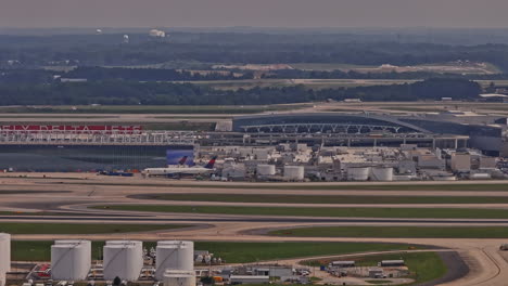Atlanta-Georgia-Aerial-v949-zoomed-tracking-shot-at-Hartsfield-Jackson-International-airport-capturing-runway-activities,-terminals-and-FAA-air-control-tower---Shot-with-Mavic-3-Pro-Cine---May-2023