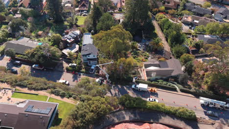 Trimming-trees-away-from-powerlines-in-Santa-Cruz,-California---aerial