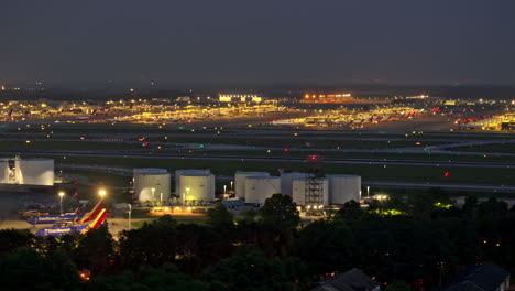 Atlanta-Georgia-Aerial-v892-hyperlapse-capturing-activities-on-the-concourse,-with-planes-taking-off-and-landing-on-the-runway-at-Hartsfield-Airport-at-night---Shot-with-Mavic-3-Pro-Cine---June-2023