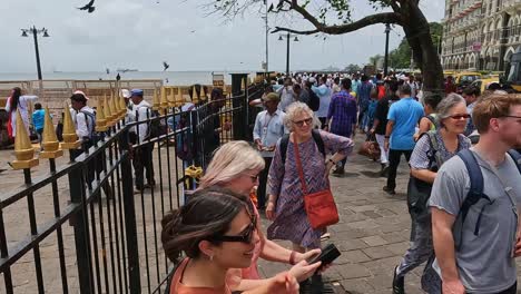 Mumbai,-India---20-August-2023:-Tourists-milling-about-taking-selfies-and-generally-enjoying-themselves-outside-the-Gateway-of-India
