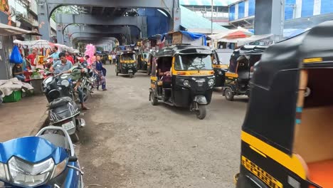 Mumbai,-Indien---20.-August-2023:-Autorikscha-Taxis,-Motorräder-Und-Menschen,-Die-Sich-Durch-Einen-Markt-In-Mumbai,-Indien-Bewegen