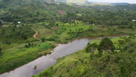 Beautiful-drone-shot-of-Malagasy-nature-including-a-river,-jungle,-mountains-and-a-protected-grassland