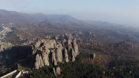 An-aerial-shot-panning-from-right-to-left-over-the-picturesque-Belogradchik-natural-rock-sculptures,-situated-west-of-the-town-of-Belogradchik,-in-Vidin-province,-Bulgaria