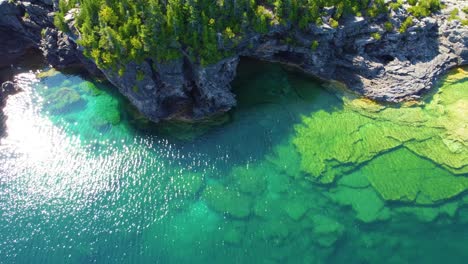 Bird's-eye-view-of-the-clear-waters-of-Lake-Huron-and-the-rocky-cliffs-on-its-banks