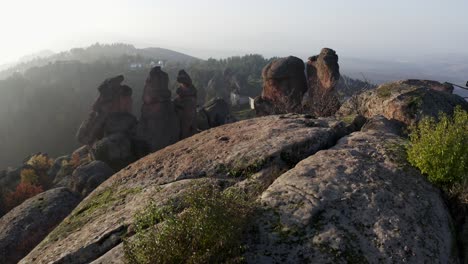 -Slow-reveal-of-the-town-and-residences-beyond-the-big-boulders-of-the-sculptural-rock-formations-of-Belogradchik-in-the-province-of-Vidin-in-Northwestern-Bulgaria