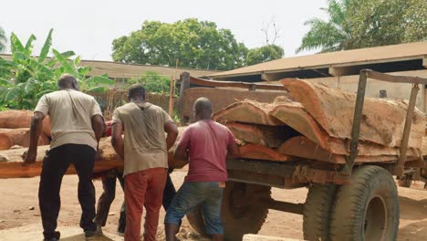 team-of-black-Ghana-African-carpenter-working-loading-a-truck-with-wooden-trunk