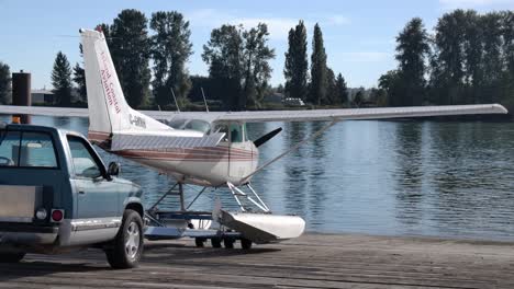 Float-Plane-Mover-Pushing-Cessna-Floatplane-On-Ramp-In-Vancouver,-Canada