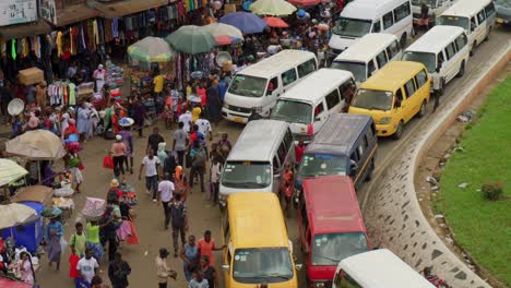 aerial-established-of-local-street-market-with-stand-and-traffic-busy-road