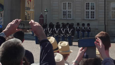 Tourists-capturing-the-changing-of-the-guard-in-Copenhagen,-Denmark