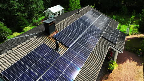 Aerial-view-around-reflecting-PV-modules-on-a-self-sufficient,-off-grid-house
