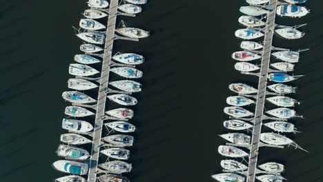 Drone-topshot-rotating-elevation-of-sailboats,-pleasure-boats-moored-on-a-French-quay