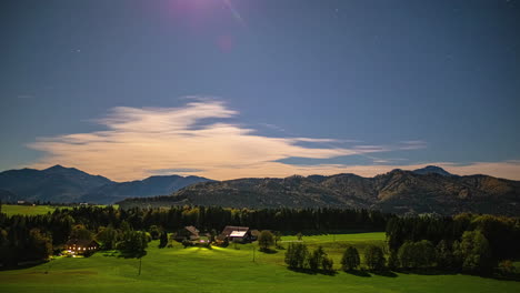 Nighttime-time-lapse-with-a-bright-moon-and-stars-over-Austria's-countryside
