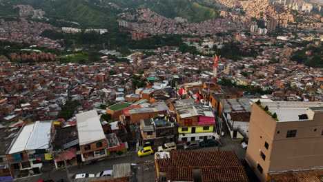 Drone-shot-over-colorful-dwellings-in-favela-Commune-13,-sunny-Medellín,-Colombia