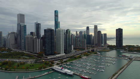 Aerial-view-backwards-from-the-lakefront,-cloudy,-fall-evening-in-Chicago,-USA