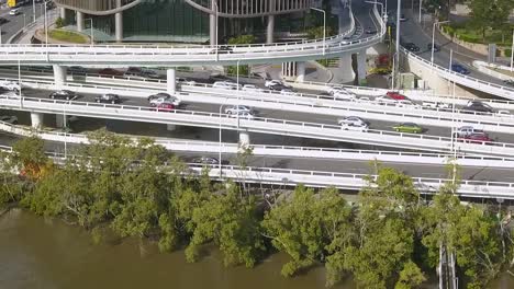 Drone-trucking-pan-follows-cars-driving-on-highway-commuting-in-city