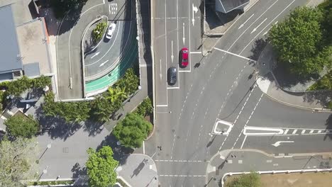 Drone-bird's-eye-view-above-pedestrians-crossing-street-intersection-in-city