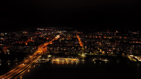 Aerial-view-in-front-of-the-illuminated-skyline-of-Vaasa,-night-in-Finland