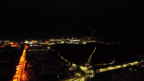Aerial-view-toward-the-Vaskiluoto-power-plant-and-terminal,-night-in-Vaasa,-Finland