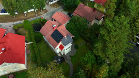 Drone-shot-around-a-modern-solar-powered-house-in-a-nordic-neighborhood