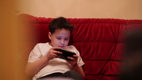 Teenager-is-playing-his-portable-game-console