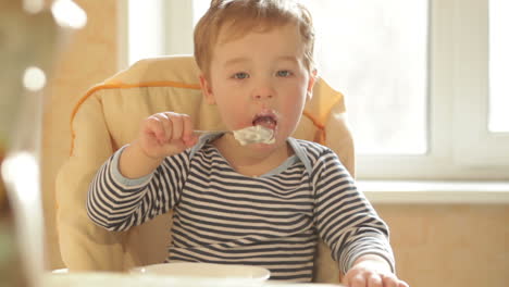 Little-boy-eats-porridge-in-the-morning