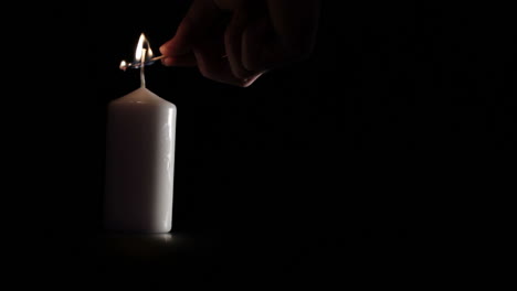 Simple-white-candle-on-black-background