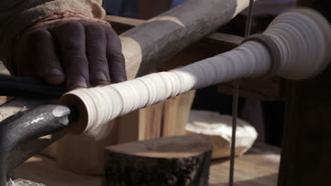 Craftsman-turning-wood-on-a-vintage-lathe