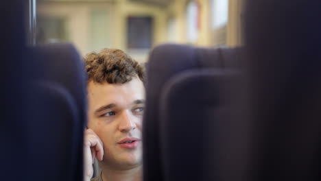 Man-talking-on-the-phone-in-train
