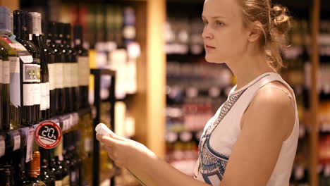 Woman-shopping-for-alcohol-in-a-bottle-store