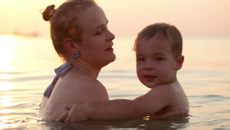 Son-and-mother-embracing-in-the-sea