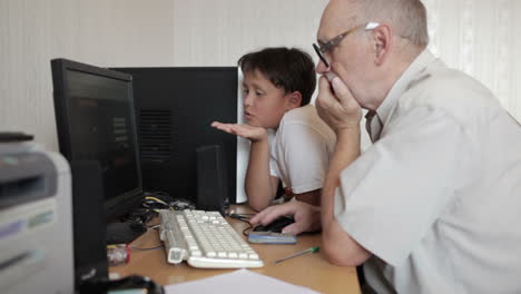 Grandfather-repairs-grandson-computer-1