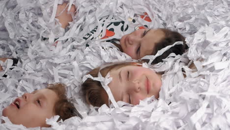 Tired-kids-lying-in-paper-after-having-a-great-party