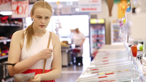 Young-woman-buying-products-at-the-supermarket