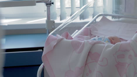 Newborn-baby-girl-sleeping-during-her-first-days-in-maternity-hospital