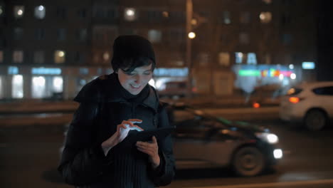 Young-woman-with-digital-tablet-in-evening-city