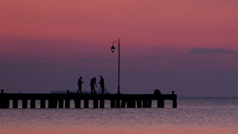 People-on-a-pier-at-sunset