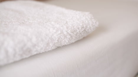 Woman-smoothing-a-fresh-white-towel