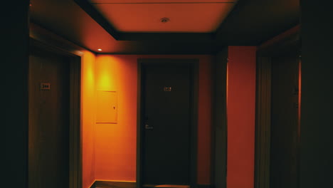 Walking-to-hotel-room-through-dark-hallway