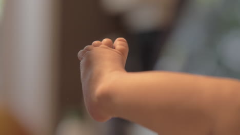 Mother-expressing-love-for-newborn-baby-with-kissing-small-feet
