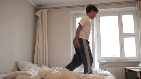 Teenager-jumps-on-the-bed