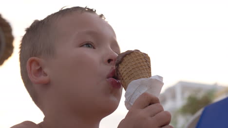 Child-eating-chocolate-ice-cream-outdoor